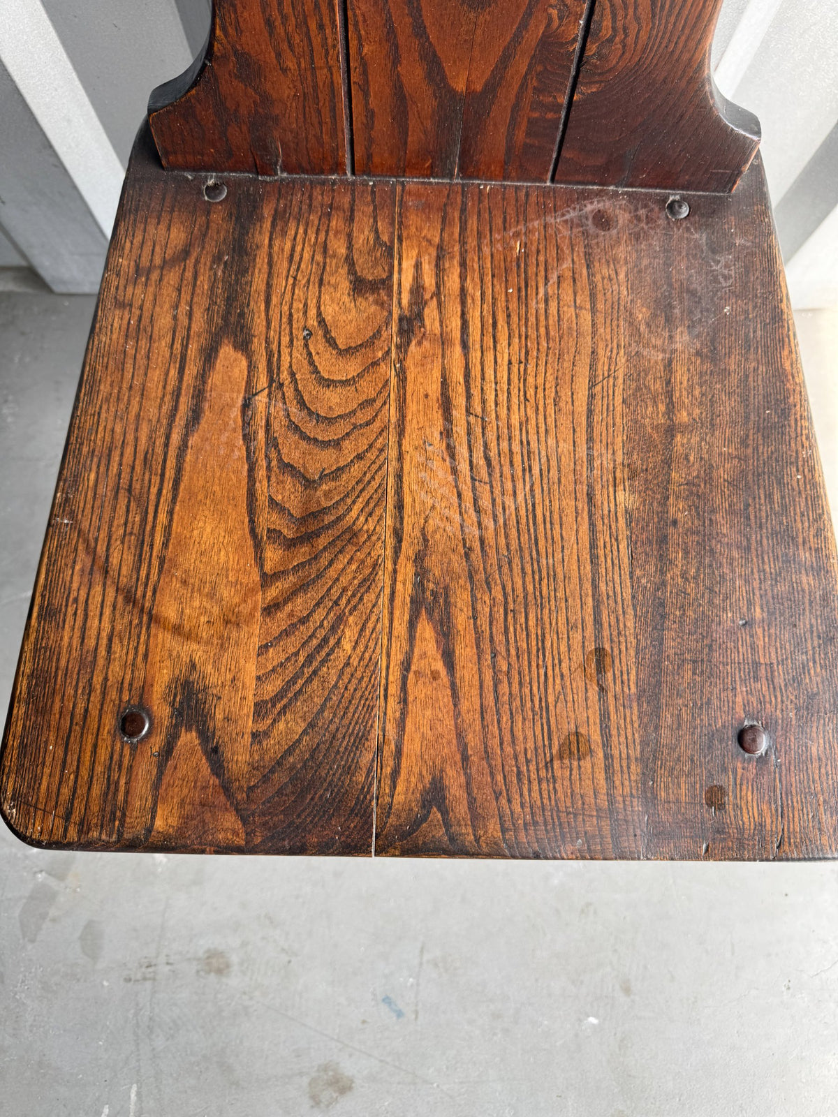 Single chair back view displaying vertical wood grain patterns and construction