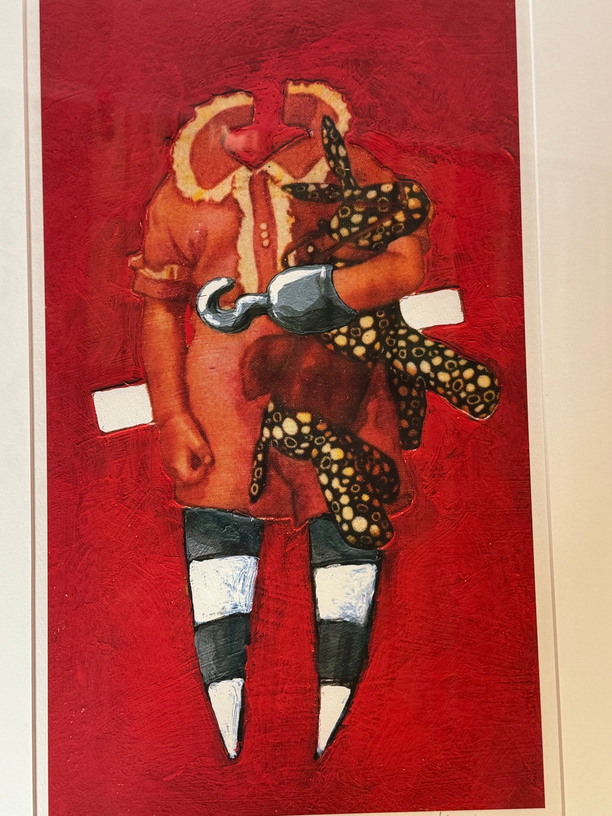 Close view of the red print with striped legs and hook hand