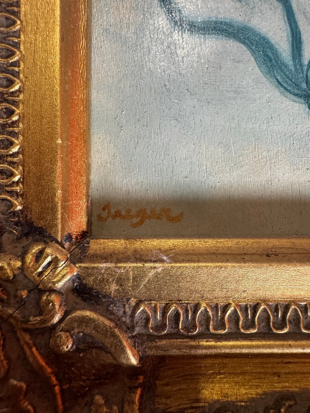 Close view of the gold cursive signature at the lower left and frame corner