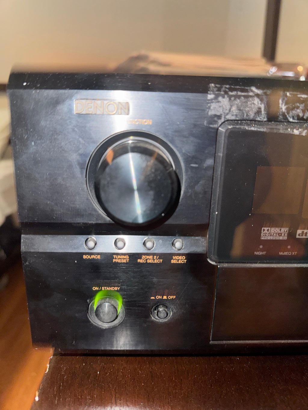 Close-up of Denon AVR-2807 front panel showing function knob and control buttons