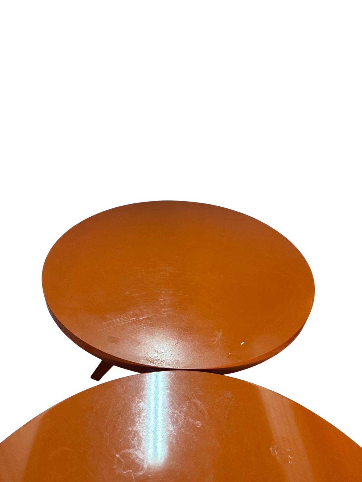 Two orange table tops seen from above showing scratches