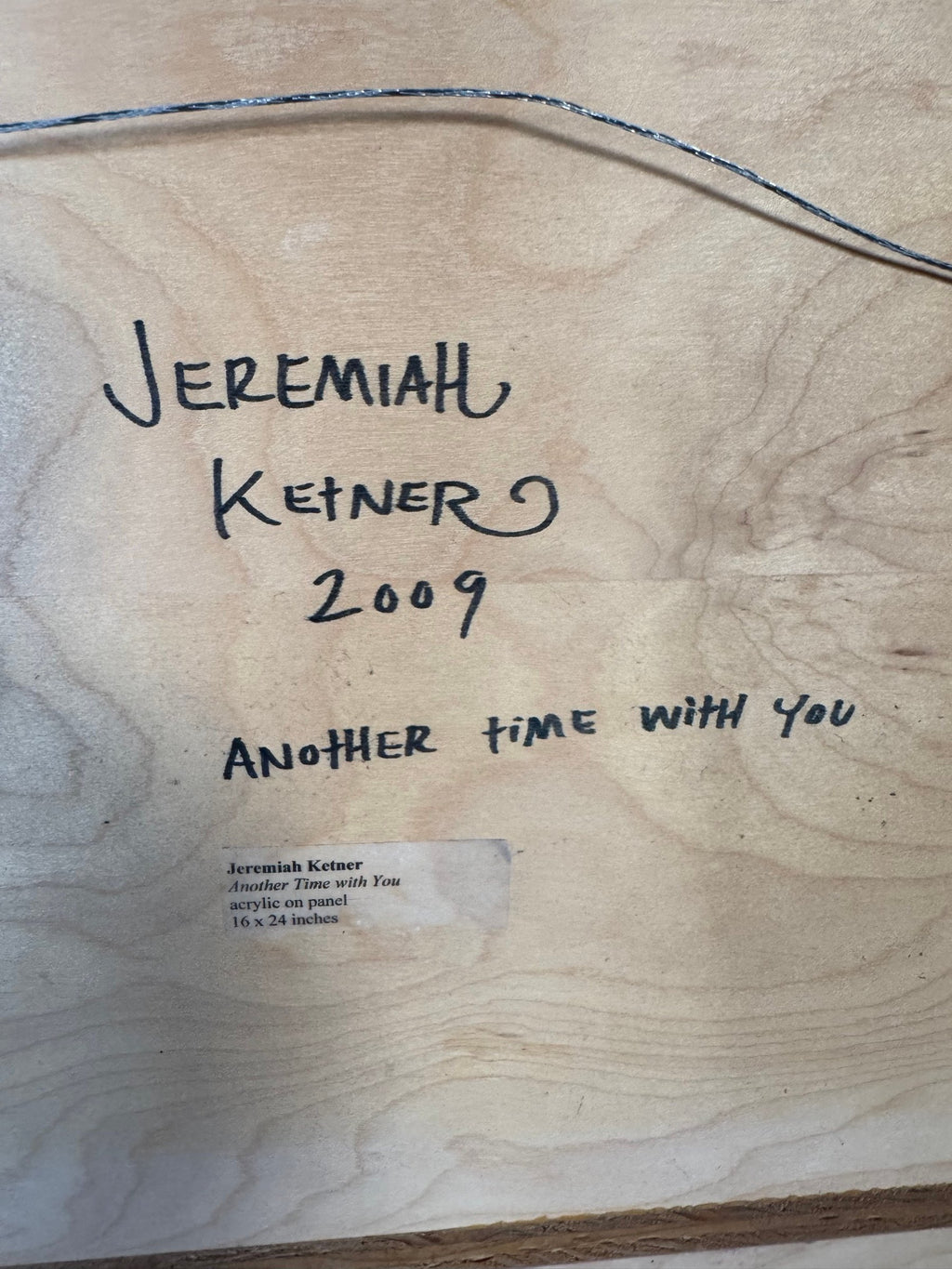 Back of the panel with signature, year, title and printed label