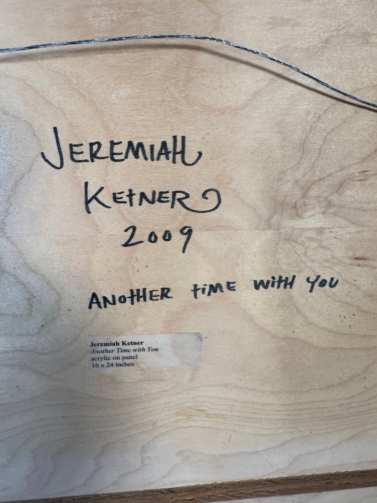 Back of the panel with signature, year, title and printed label