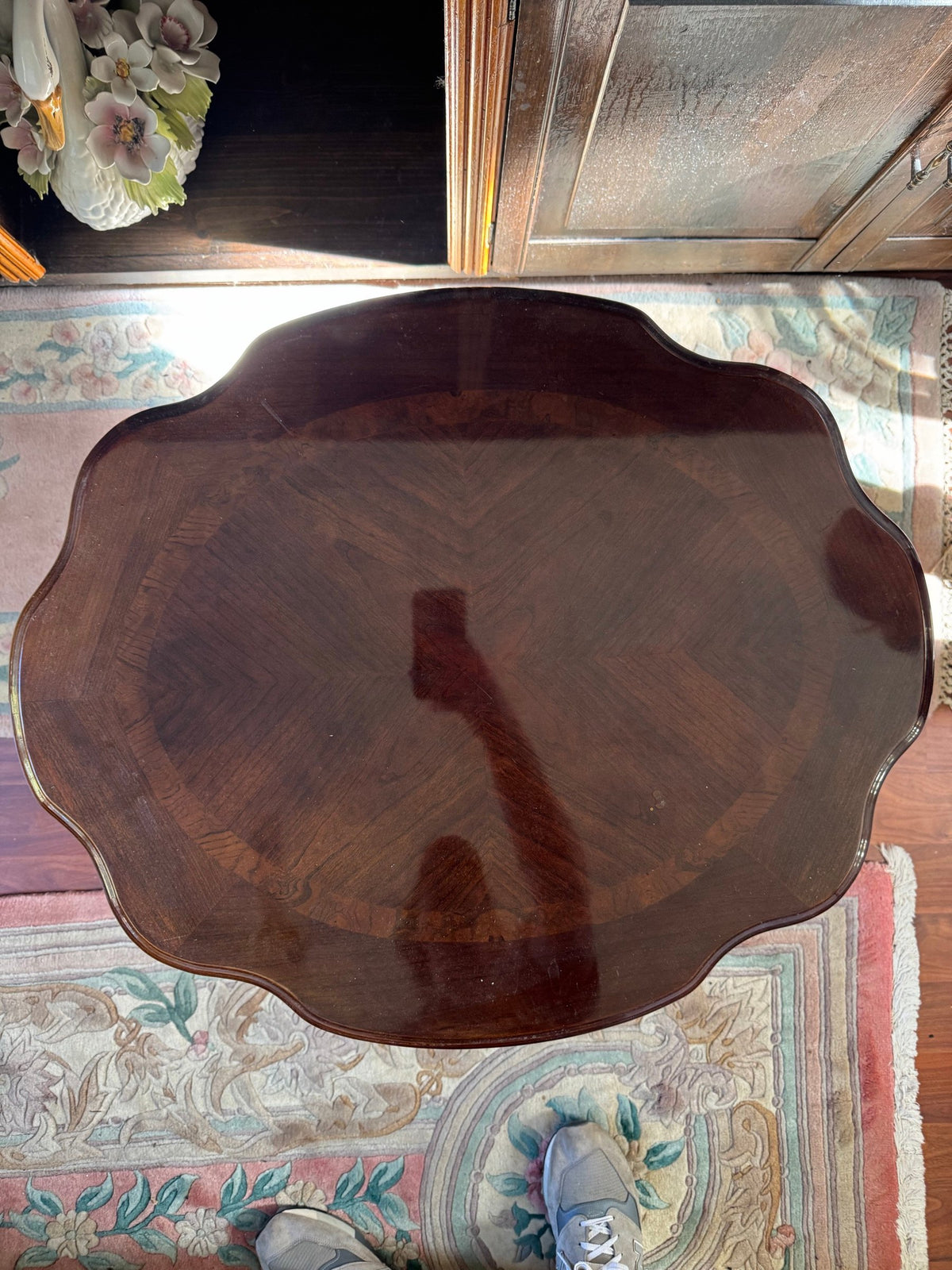 Top view of the scalloped oval top with a diamond-matched wood pattern
