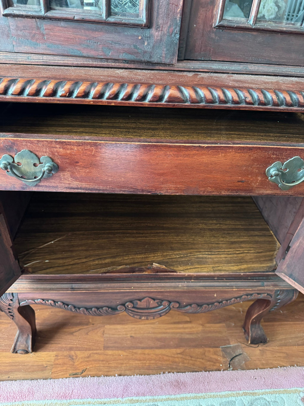 Lower drawer pulled open with brass-tone pull