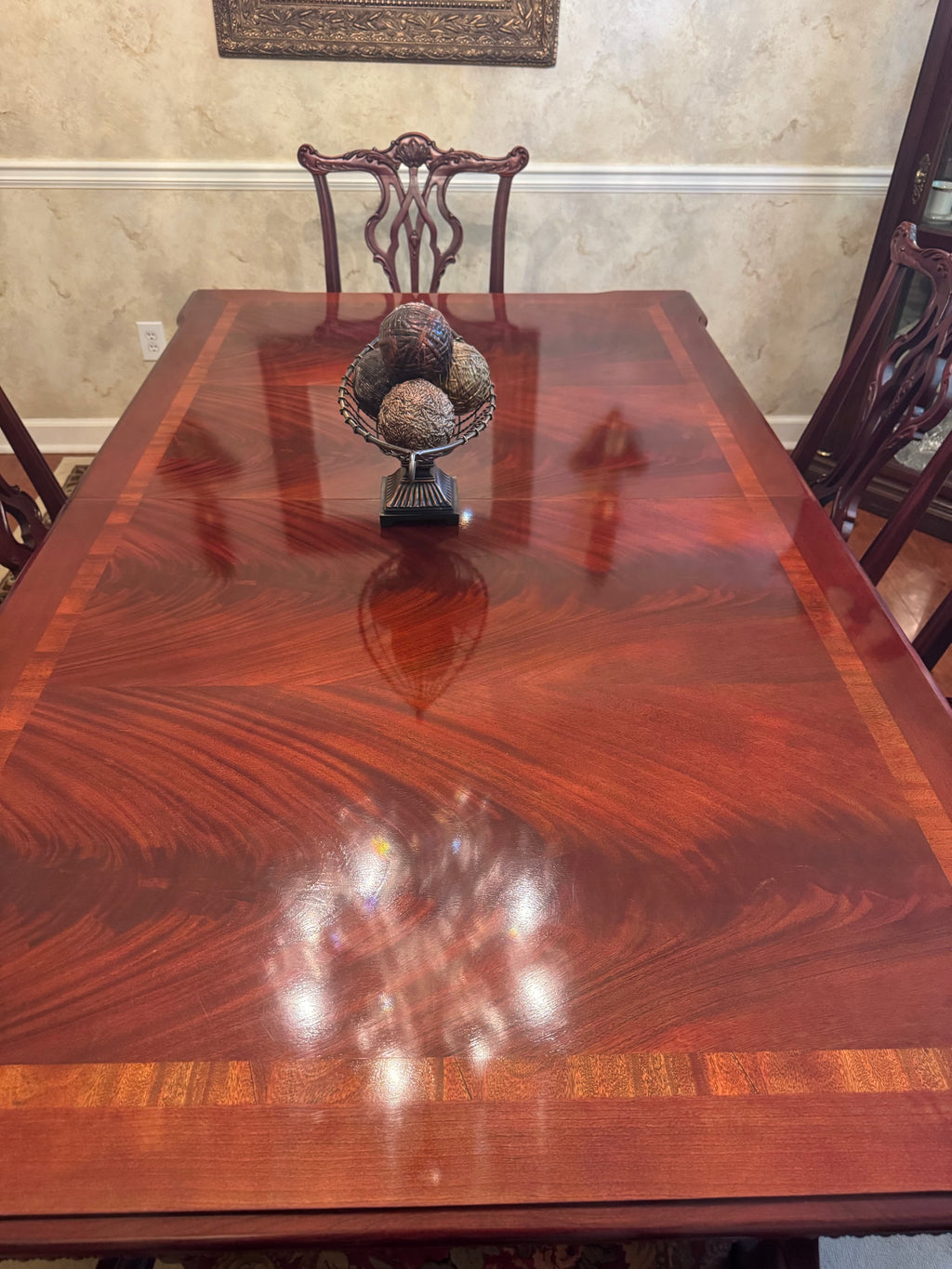 Overhead view of the mahogany table top showing wood grain and inlay banding