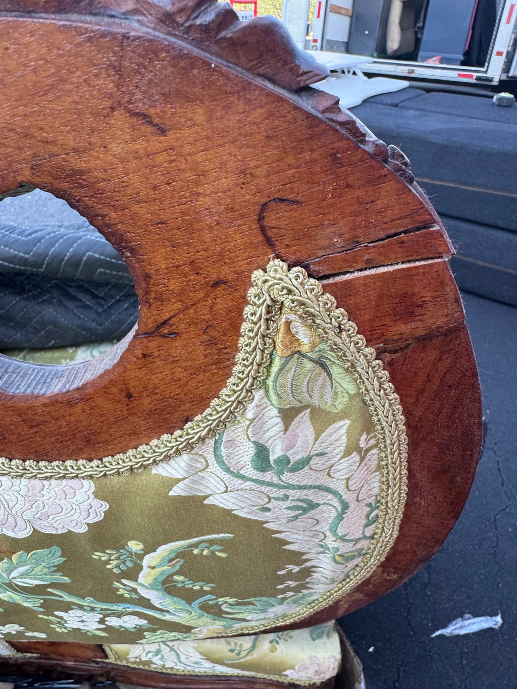 Condition detail: an open split running across the back frame of the chair