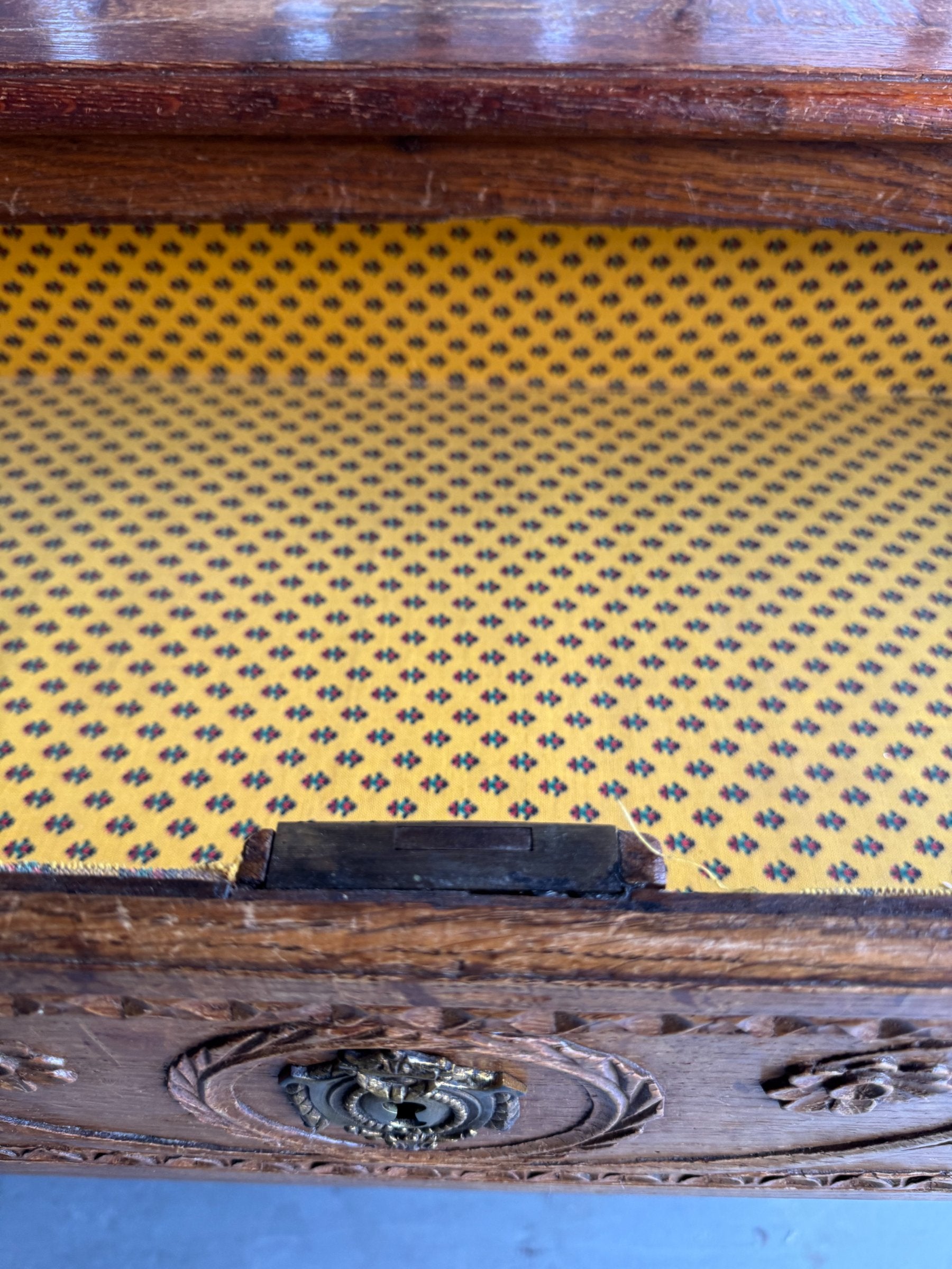 Side profile displaying the piece's depth, carved drawer fronts, and leg proportions