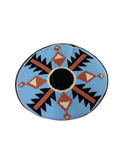 Round needlepoint pillow front featuring Southwestern design with blue background, black thunderbird motifs, rust and cream diamond patterns, and black center circle