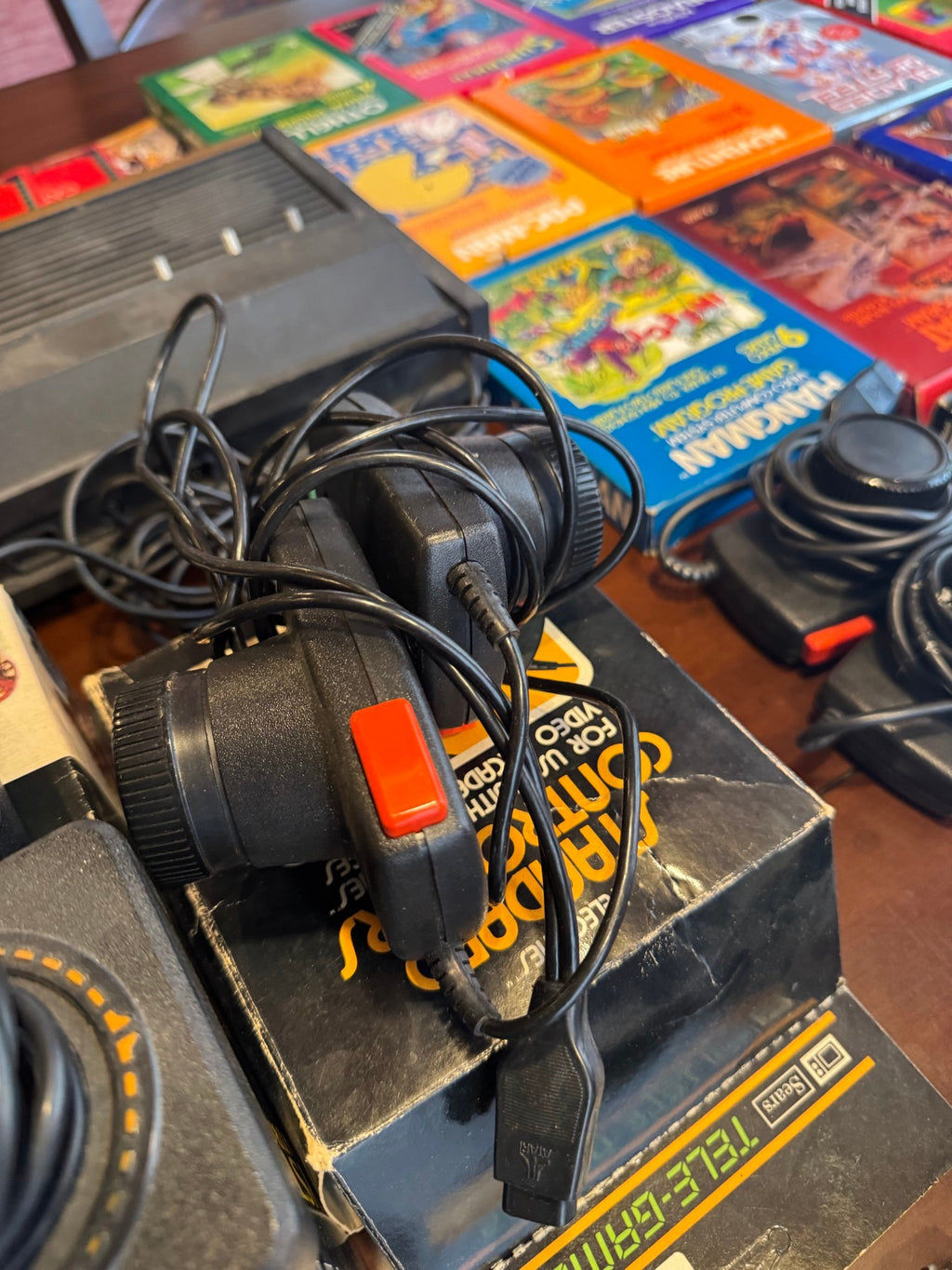 The Barch Atari 2600 collection laid out: console, joystick and paddle controllers, and the boxed cartridges named in the description