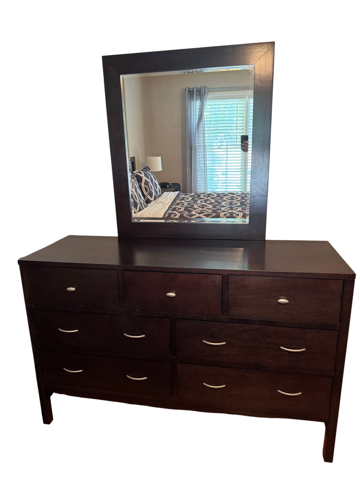 Espresso finish 7-drawer wood dresser with matching beveled mirror on top, shown in a bedroom setting