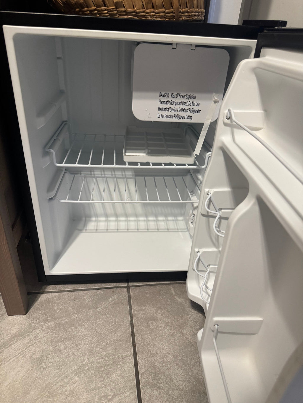 Open fridge showing shelves and door