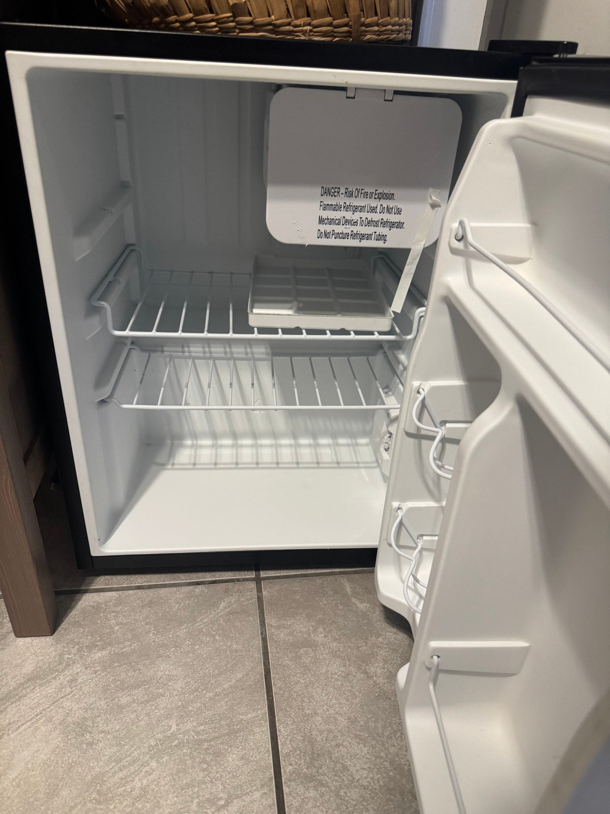 Open fridge showing shelves and door