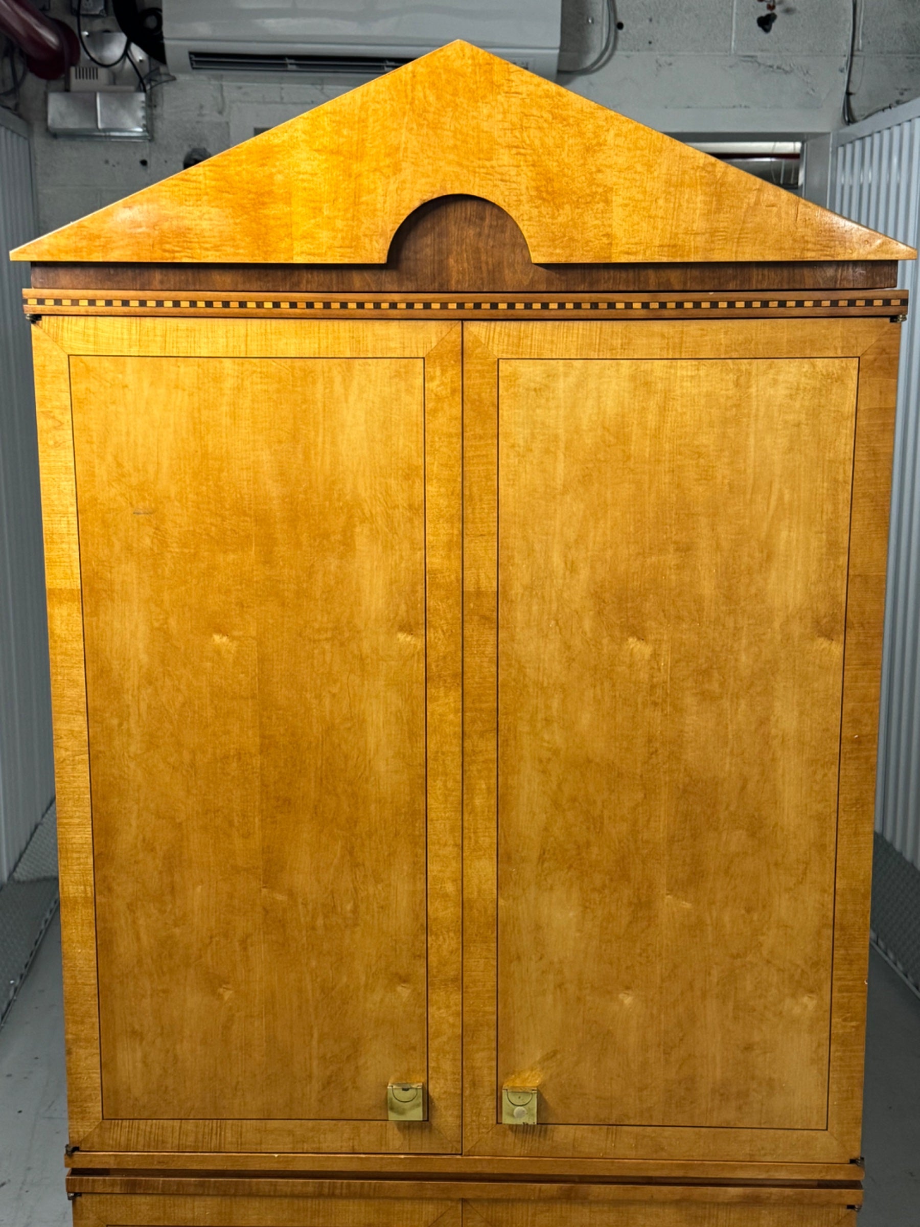 Pediment top with curved semicircle cutout detail and blonde wood grain visible