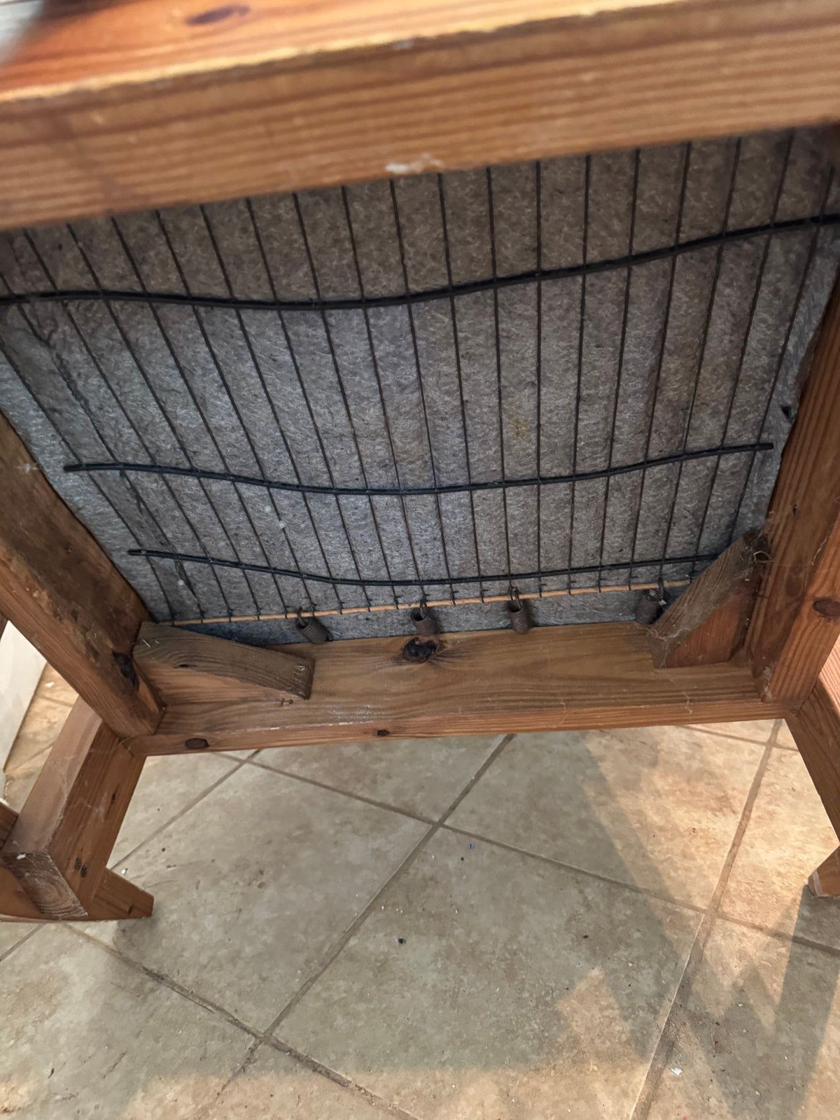 Underside of the seat with webbing and wire springs