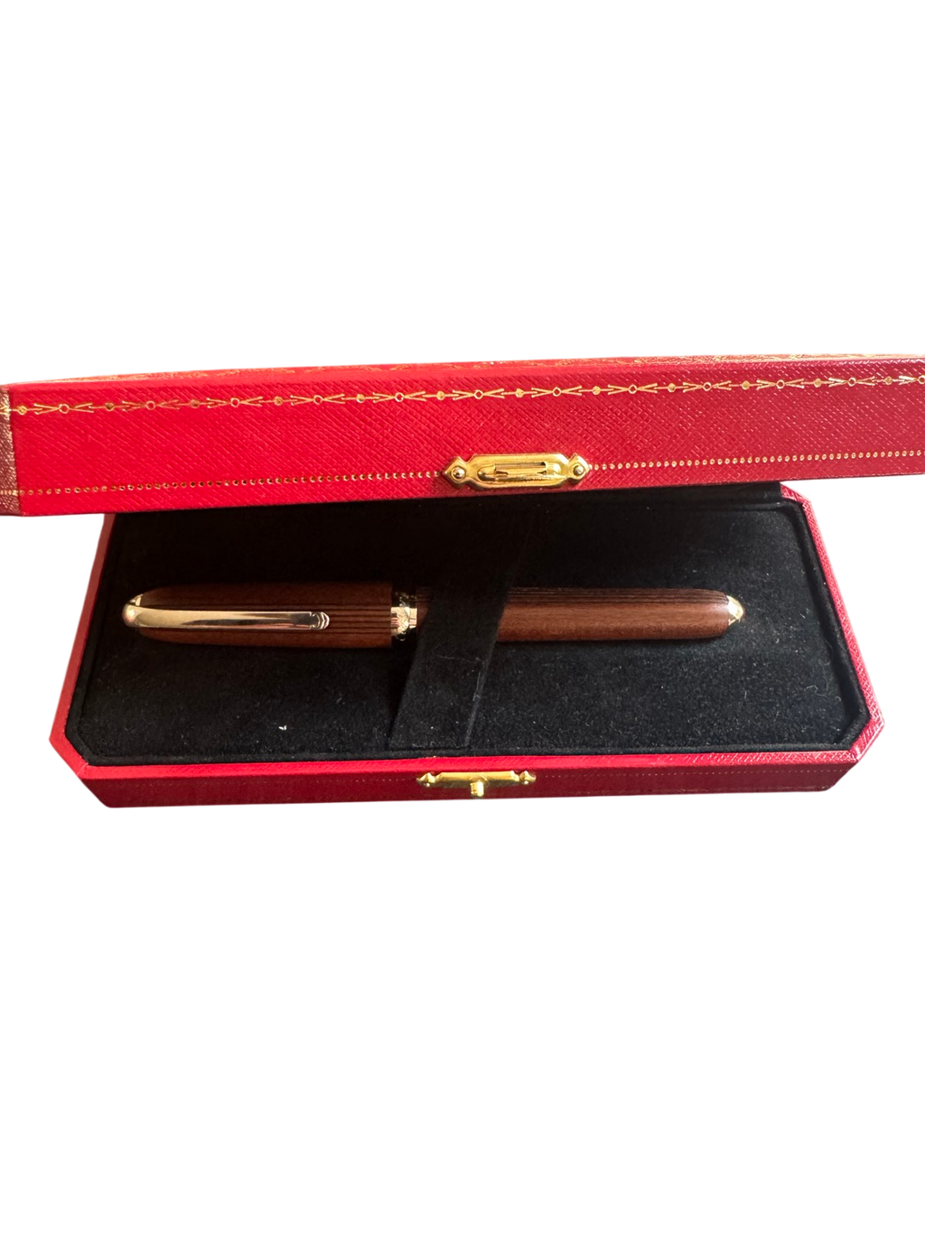 Red leather presentation box with gold-tooled trim, open to reveal black velvet interior holding two wooden pens