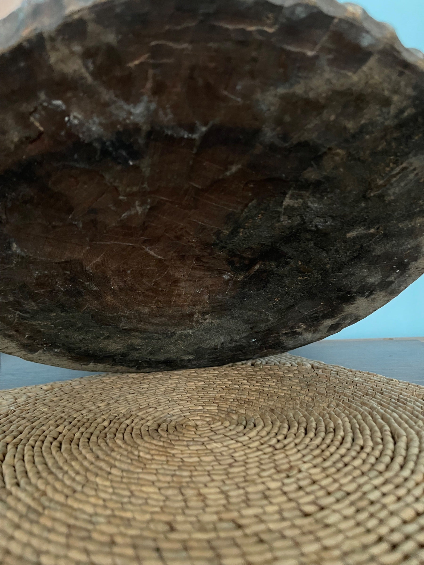 Close-up of base showing woven natural fiber mat with visible circular weaving pattern