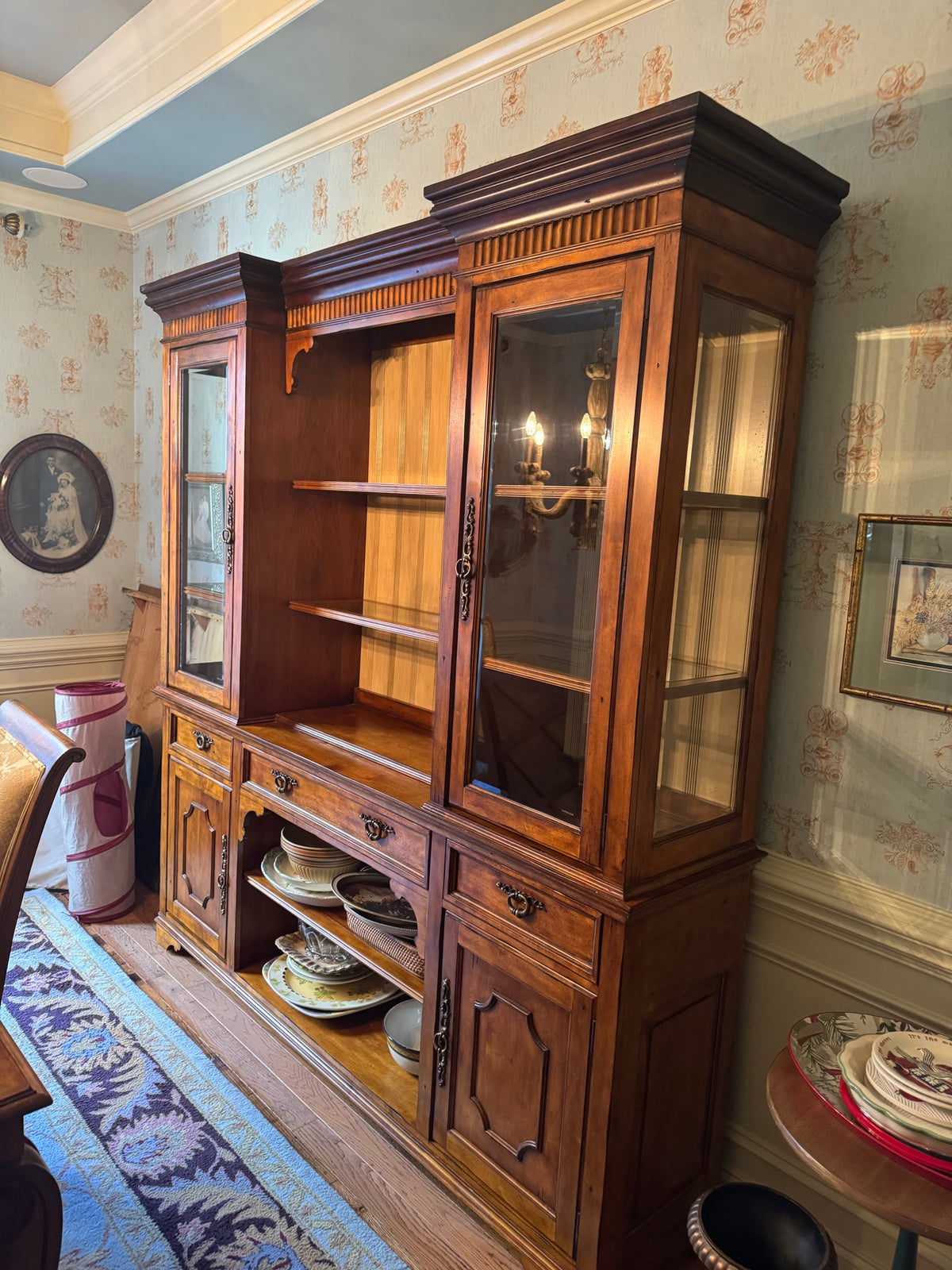 Broyhill china hutch full front view, wood construction with glass doors, open shelving center, lower storage drawers, decorative hardware