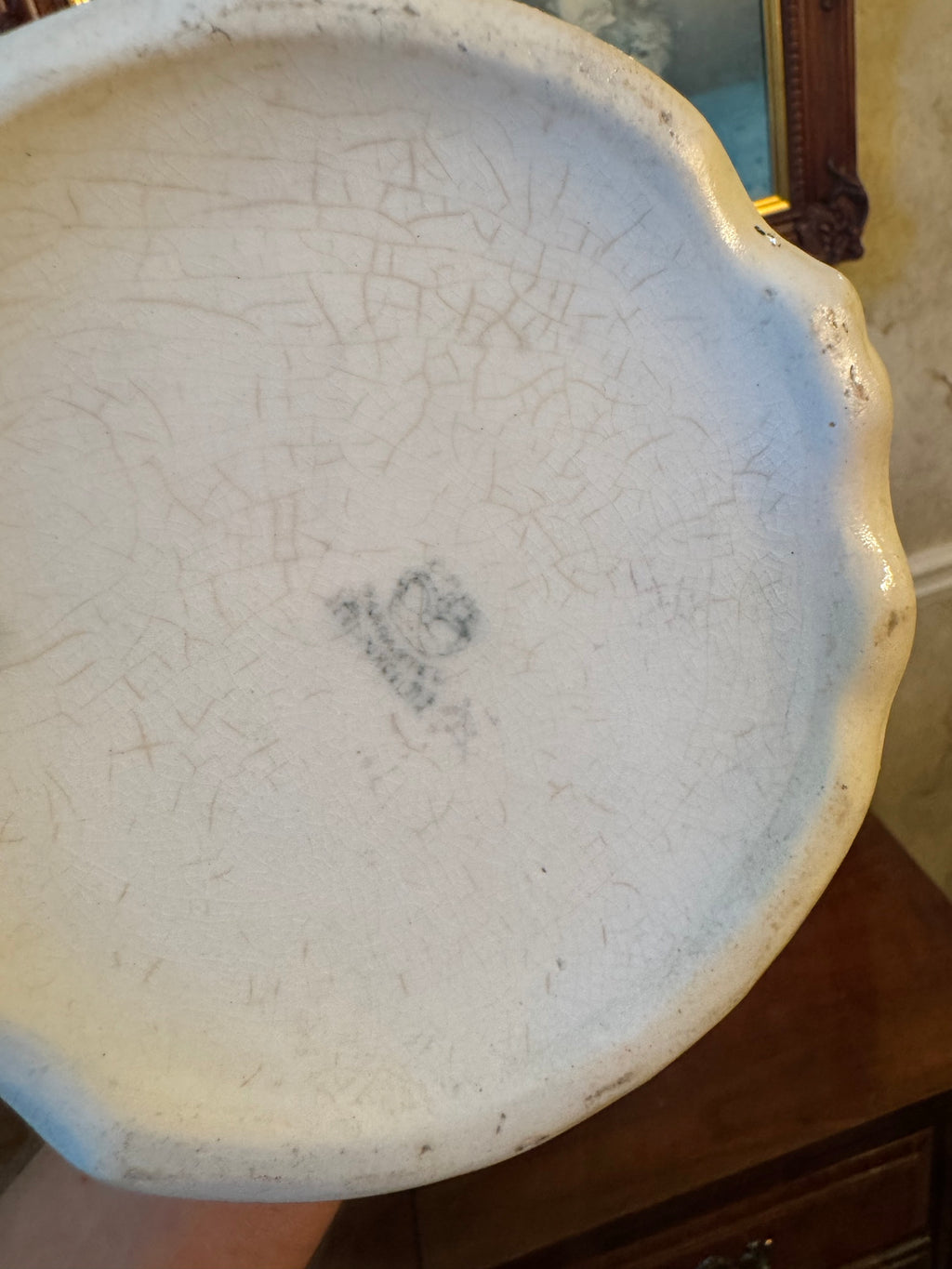 Underside of the ironstone bowl showing surface crazing and a faint impressed maker's mark