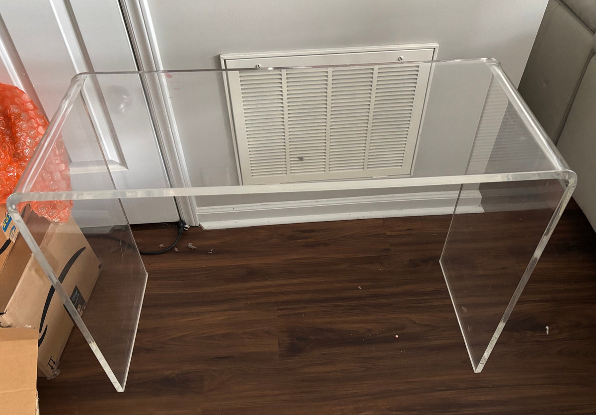Clear acrylic waterfall table indoors