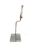 Table lamp with bent chrome arm on a clear lucite slab base, no shade