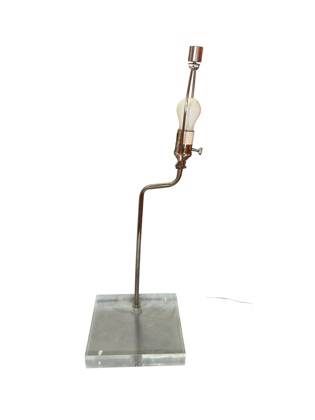 Table lamp with bent chrome arm on a clear lucite slab base, no shade