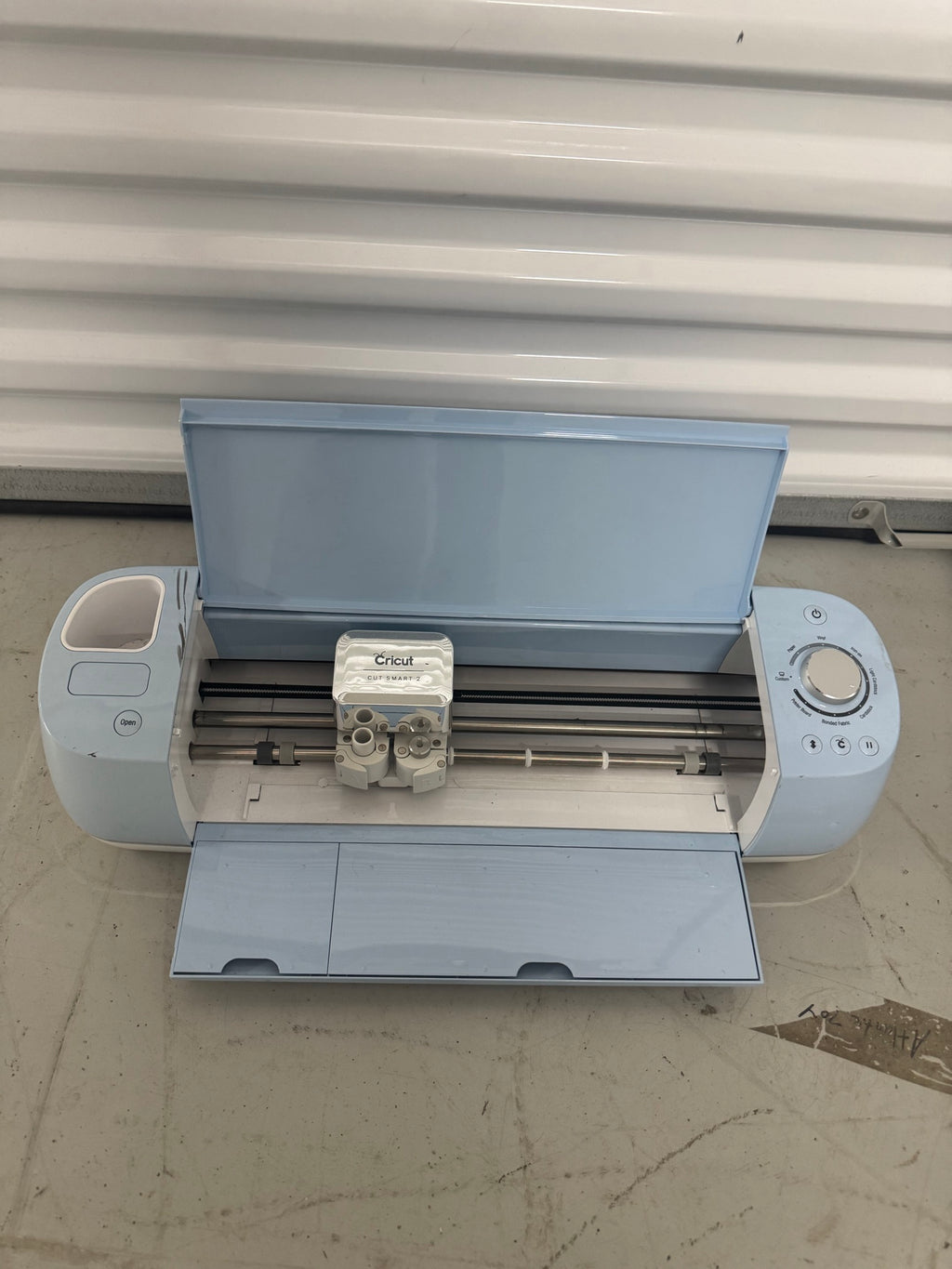 Cricut Explore Air 2 opened from above showing cutting blade cartridge and internal mechanics