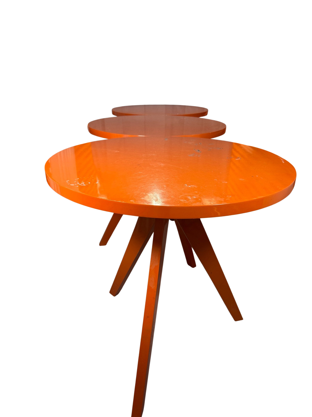 Three orange round tables in a row