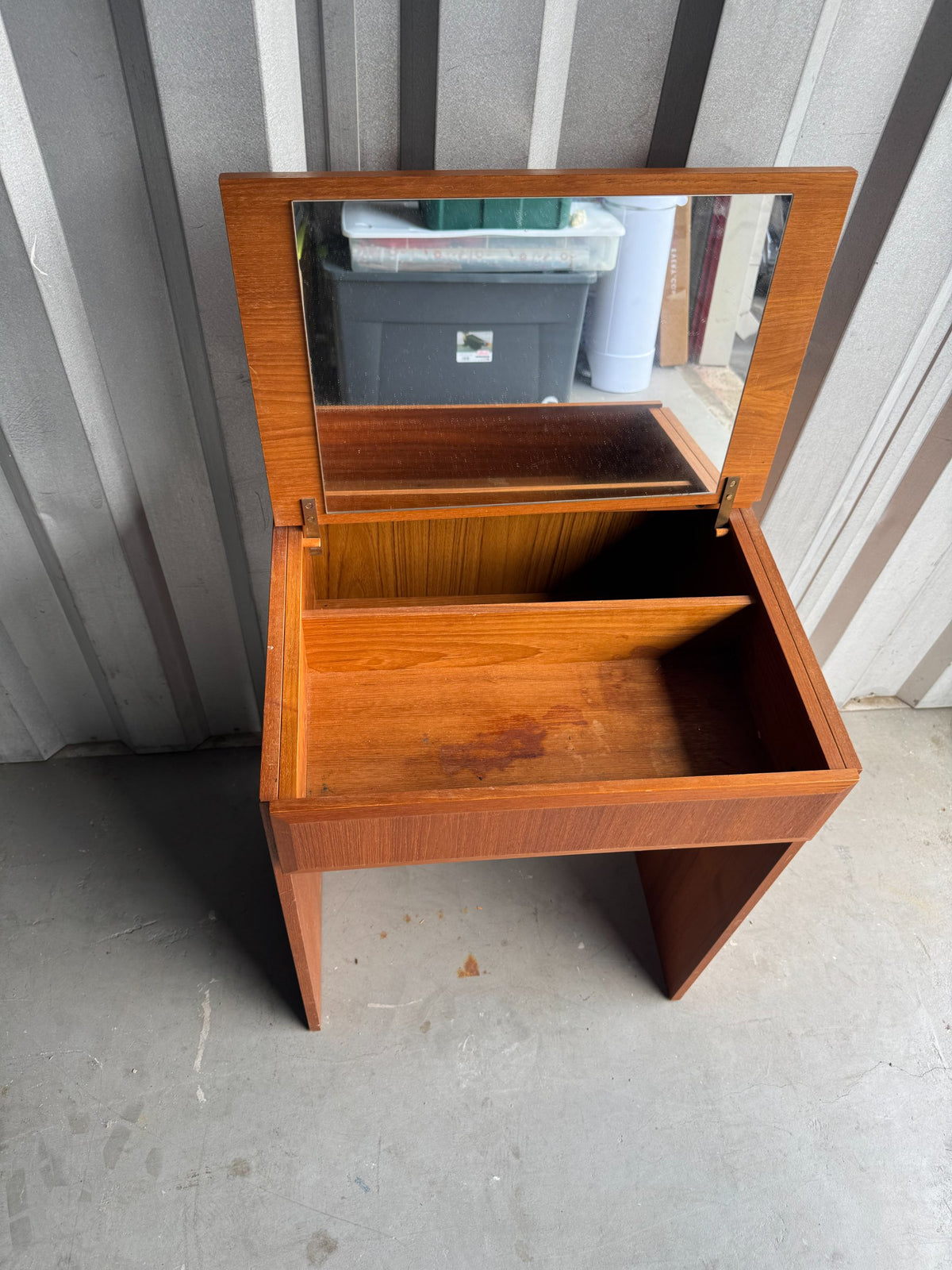 Interior view with hinged mirror lid open, revealing empty storage compartment with divided sections