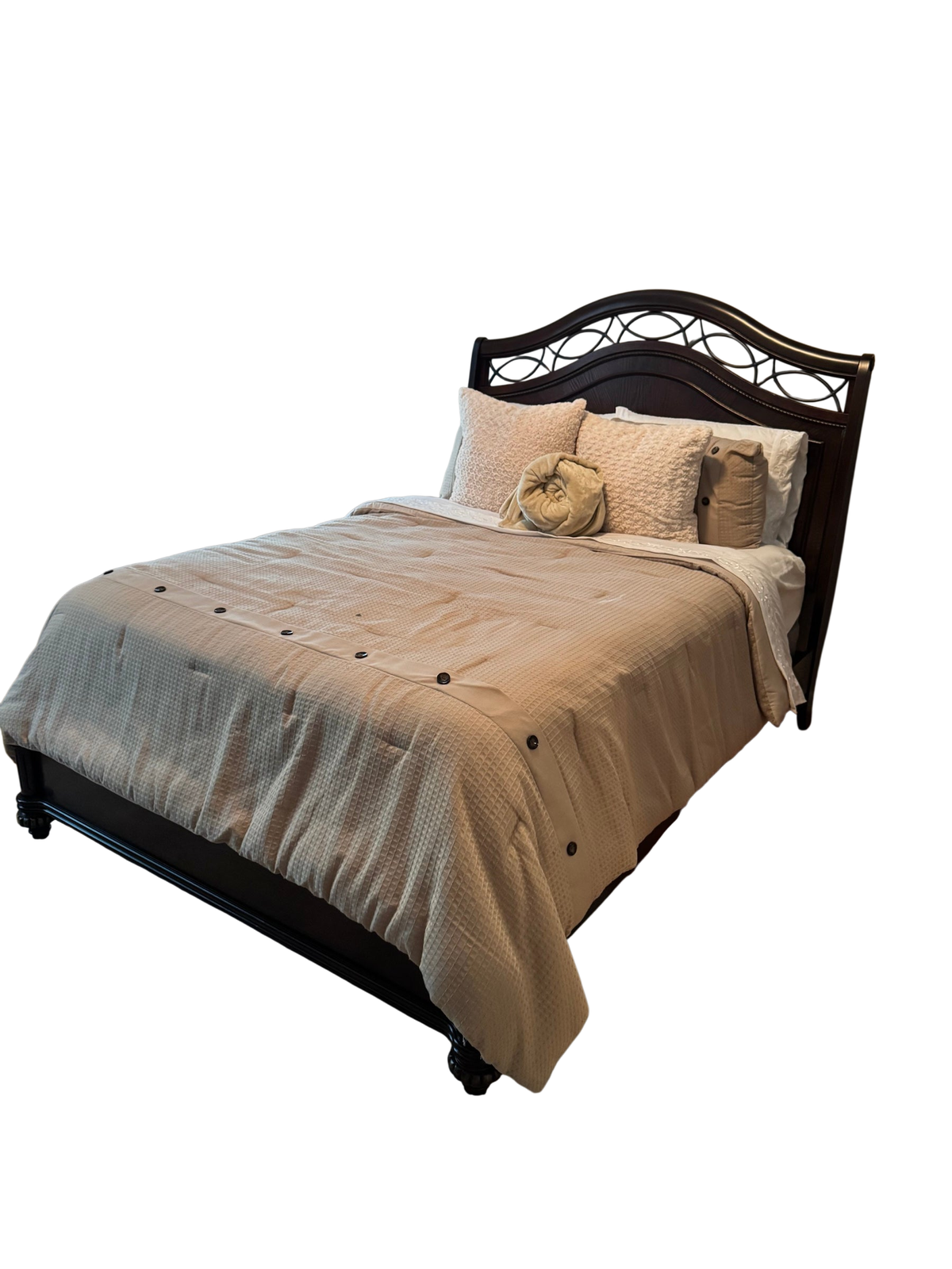 Dark cherry queen bed frame with arched, metal-inset headboard in a bedroom setting, dressed with tan bedding and pillows