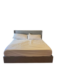 Grey upholstered king platform bed with wingback headboard