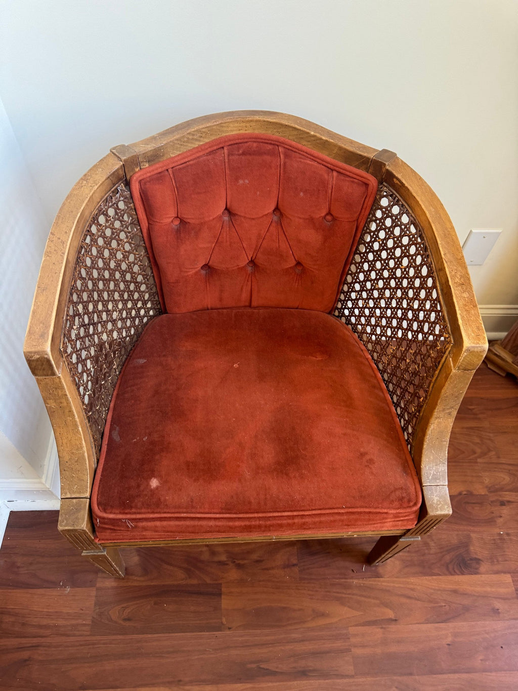 Barrel chair from a three-quarter angle showing the caned side panels