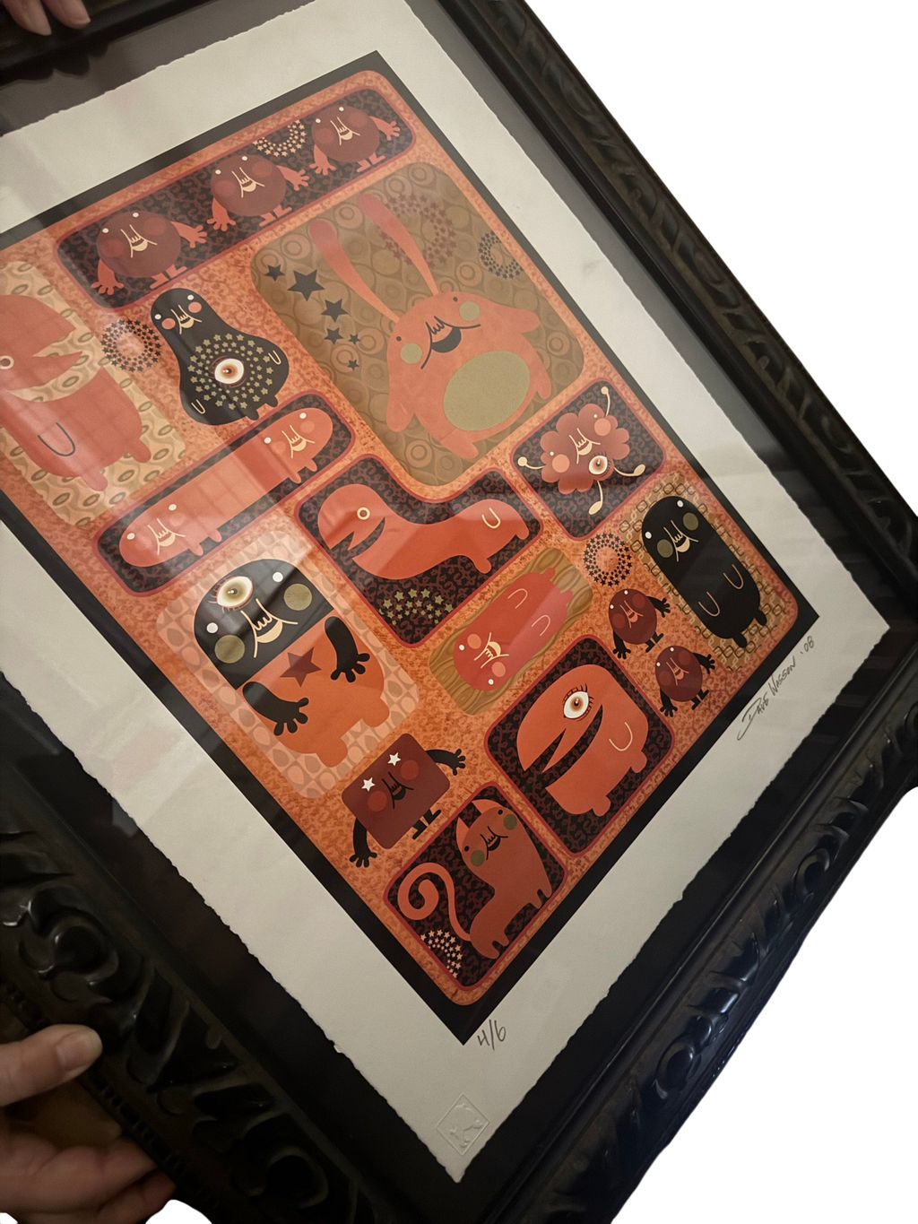 Framed orange monster grid screenprint with torn deckle edge in a black ornate frame