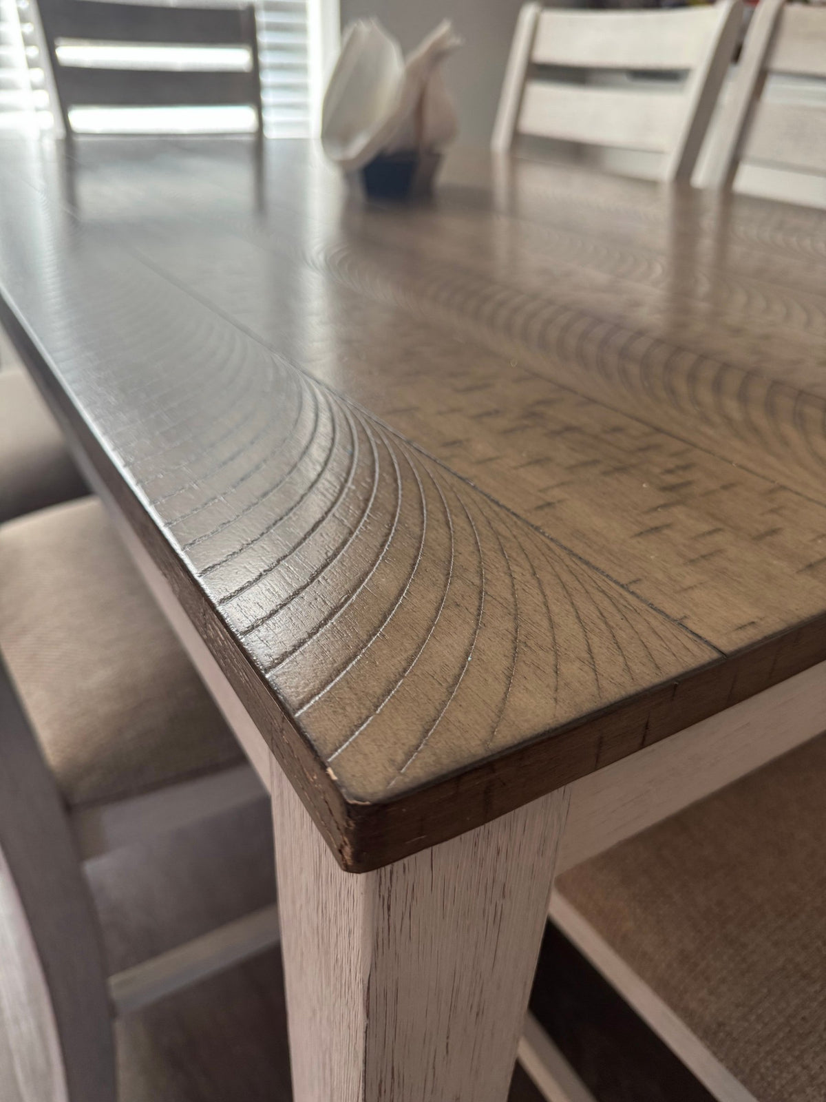 Corner of the Skempton tabletop showing the plank-look finish